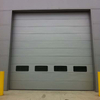 Silver grey color Micrograin style sectional industrial door with windows 