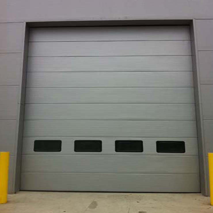 Silver grey color Micrograin style sectional industrial door with windows 